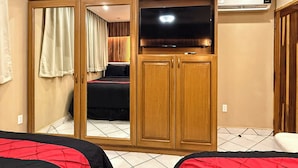 A bedroom with a wardrobe, a bed, and a television. - A-303 Enjoy Your Vacation In This Delightful Remodeled Condominium! (Cabo San Lucas)