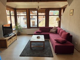 Charming Apartment | Living area | 80-inch Smart TV with cable channels