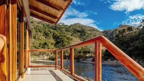 A wooden deck with a railing overlooking a river and forested hills. -  La Dulce Vista Hotel & Villas - Sierra Madre Puerto Vallarta (Puerto Vallarta)
