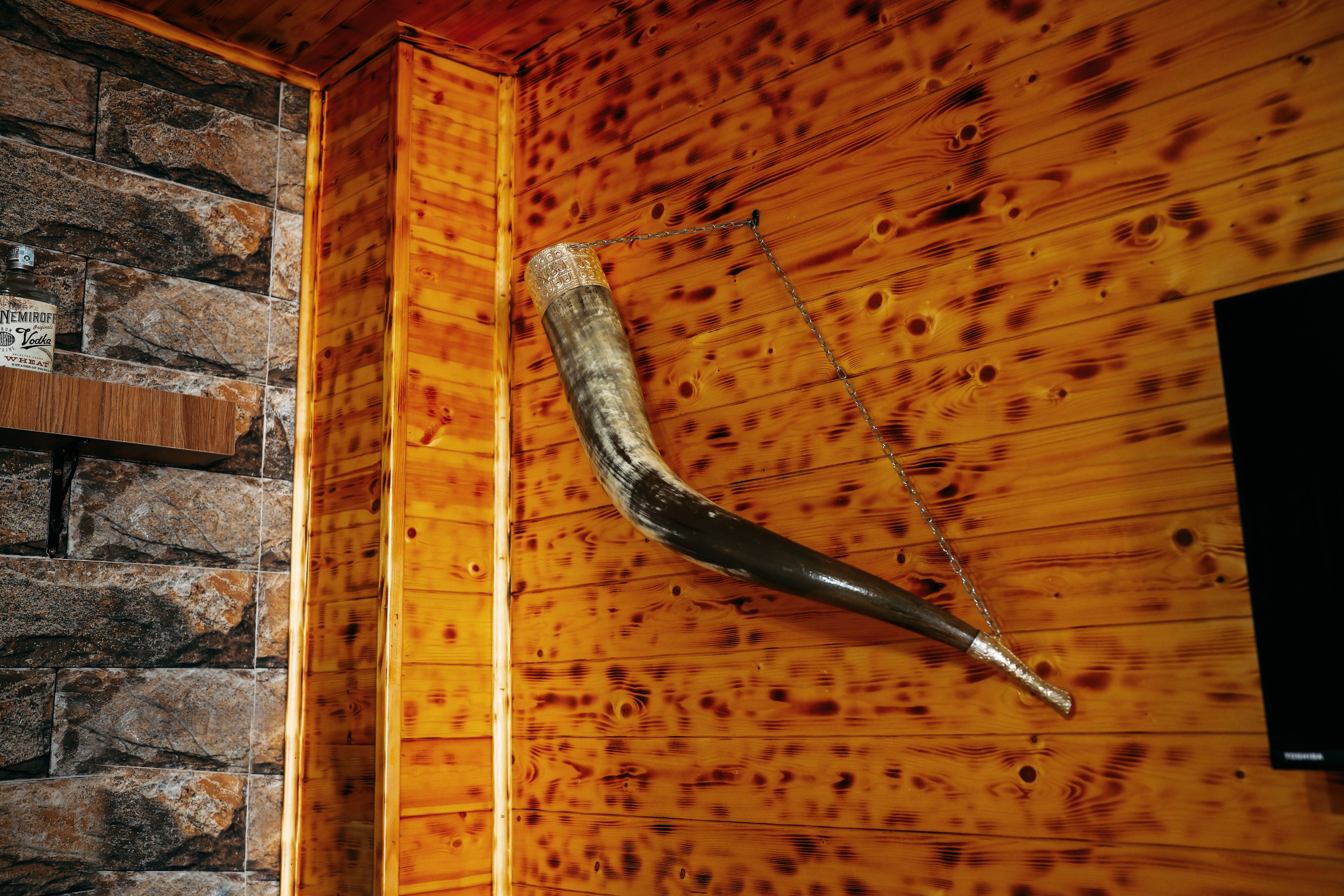 A wooden wall with a mounted hockey stick.