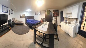 A compact living space with a kitchenette, a dining area, a sofa, a TV, and a bed. - AMAZING PRIVATE QUIET & COMFORTABLE SHORT STAYS!! 
KING SZ BED.10 mins from JFK (Queens)