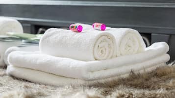 A stack of white towels on a fur-like surface.