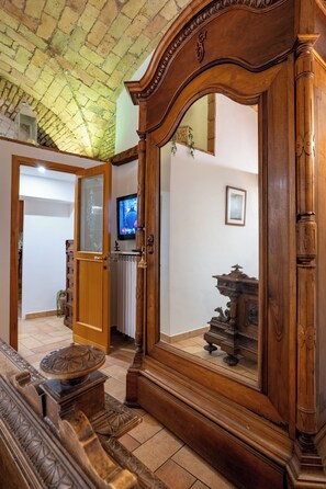 A room with a wooden cabinet, a television, and a mirror. - Domus Gelsomino, St Peter's Square, Vatican, Central Rome (Rome)