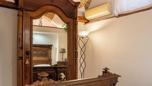 A bedroom with a large wooden bed, a mirror, a brick ceiling, and a white towel on the bed. - Domus Gelsomino, St Peter's Square, Vatican, Central Rome (Rome)