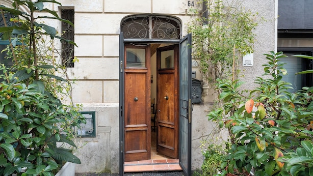 A wooden door with a metal frame, a tiled entrance, and a small step leading up to it. - Domus Gelsomino, St Peter's Square, Vatican, Central Rome (Rome)