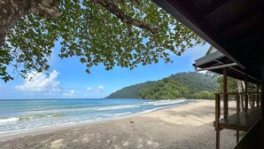 A beach with a wooden structure providing shade. - Mt. Plaisir Estate Hotel (Grande Riviere)
