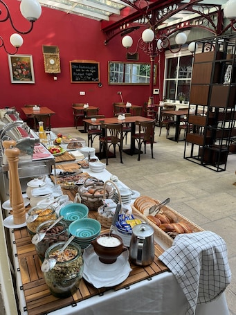 A breakfast buffet with various food items and a coffee station.
