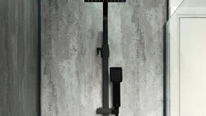 A modern shower with a handheld showerhead and a fixed rain showerhead mounted on a wall.