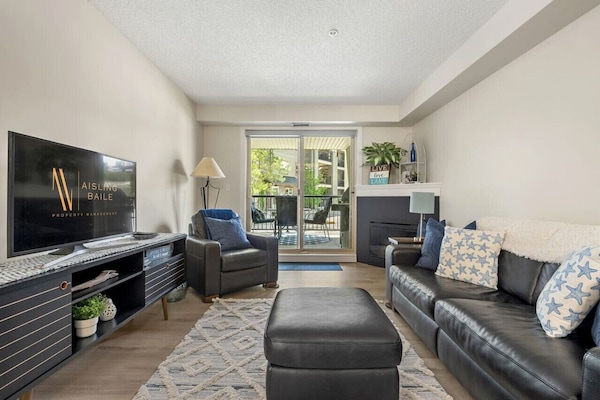 Living room with fireplace, Smart TV with cable, board games & access to the private ground-floor patio.