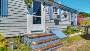 A house with a blue exterior, a white front door, and a small porch with steps leading up to it. - Family-Friendly Home! Walk to Sea Street Beach (Dennis Port)