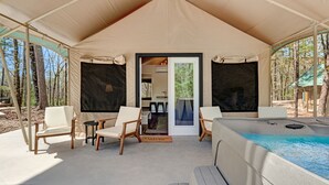 A tented accommodation with a pool, two chairs, and a table. - Loblolly Pine Luxury Glamping Tent Suite at Starlight Haven Resort (Hot Springs)
