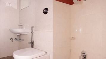 Een badkamer met een wit wastafel, toilet en douche.