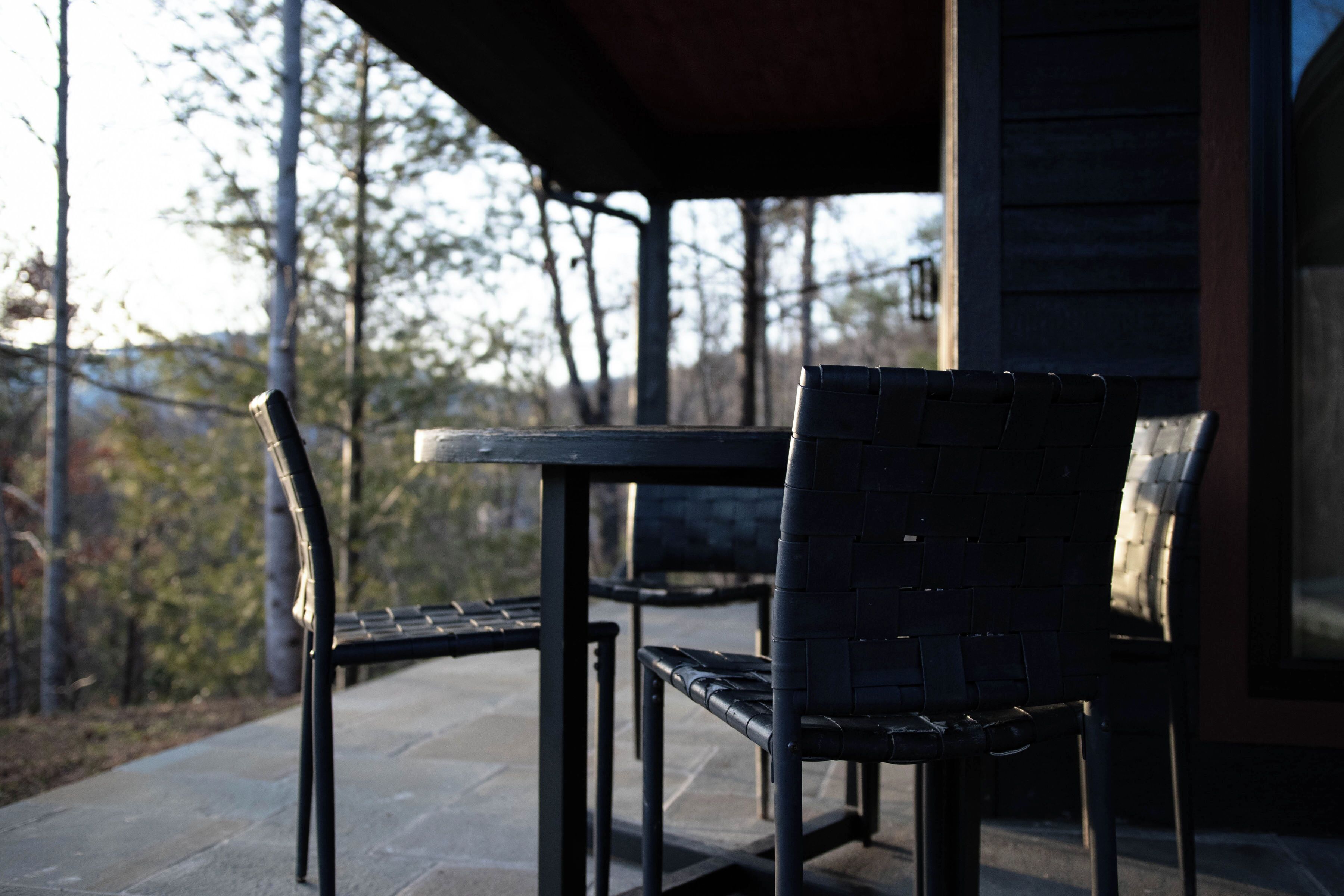 An outdoor patio with a table and two chairs.