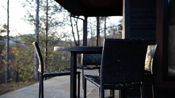 An outdoor patio with a table and two chairs.