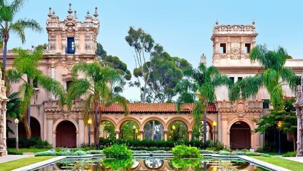 A historic building with ornate architecture, a central courtyard, and a reflective water feature. - Canyon Treehouse (San Diego)