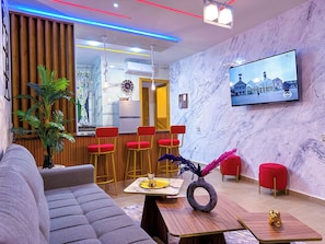 City Apartment, 2 Bedrooms, Balcony, Garden View | Living area | 65-inch Smart TV with satellite channels, Netflix, streaming services - VELUXA - Luxury Holiday Homes - Centric flat (Tangier)