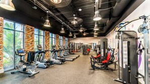 A gym with treadmills, elliptical machines, and weight equipment.