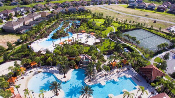 A resort with multiple swimming pools, a water park, and a tennis court.