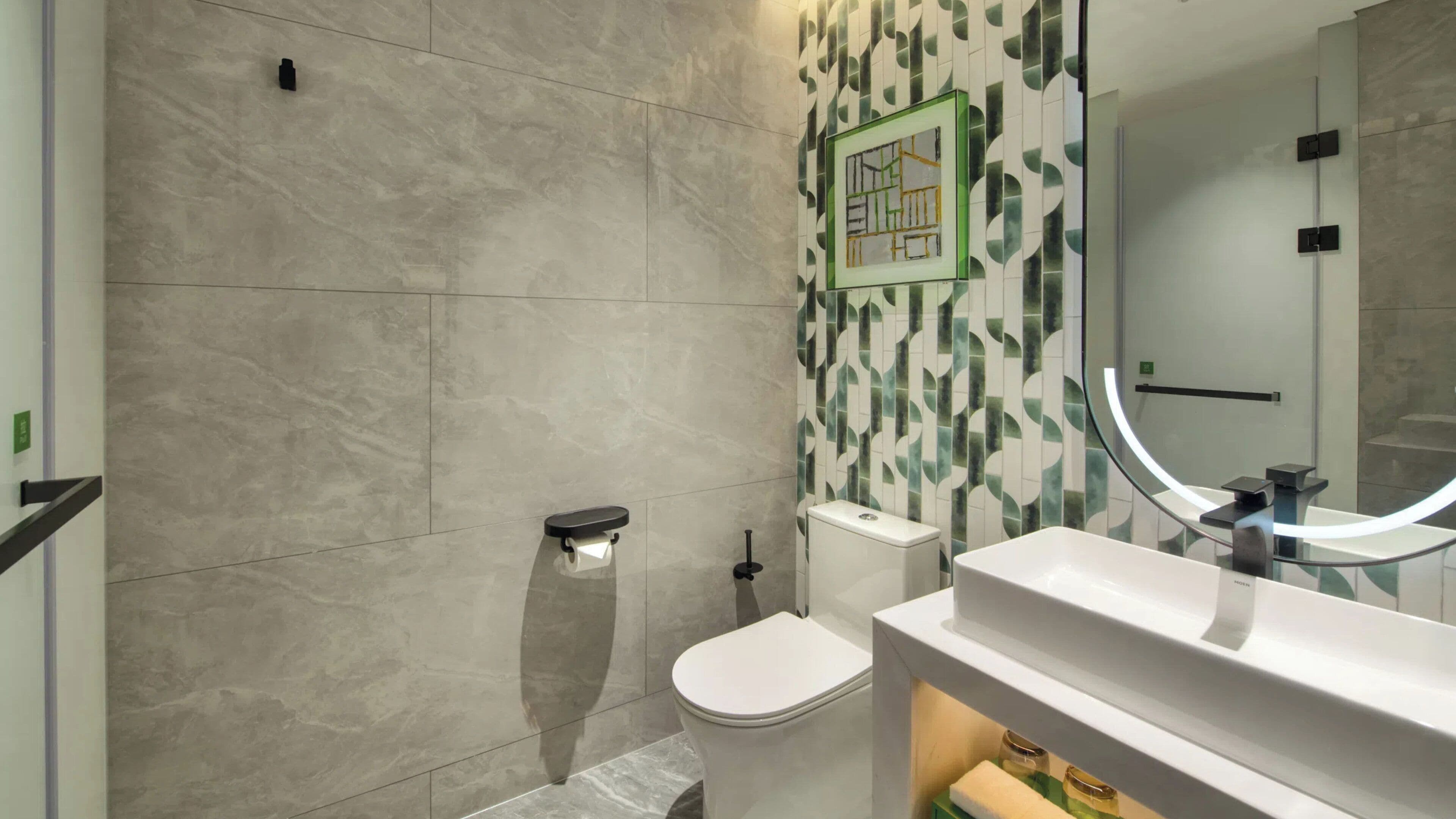 A modern bathroom with a toilet, bidet, and a sink with a mirror.