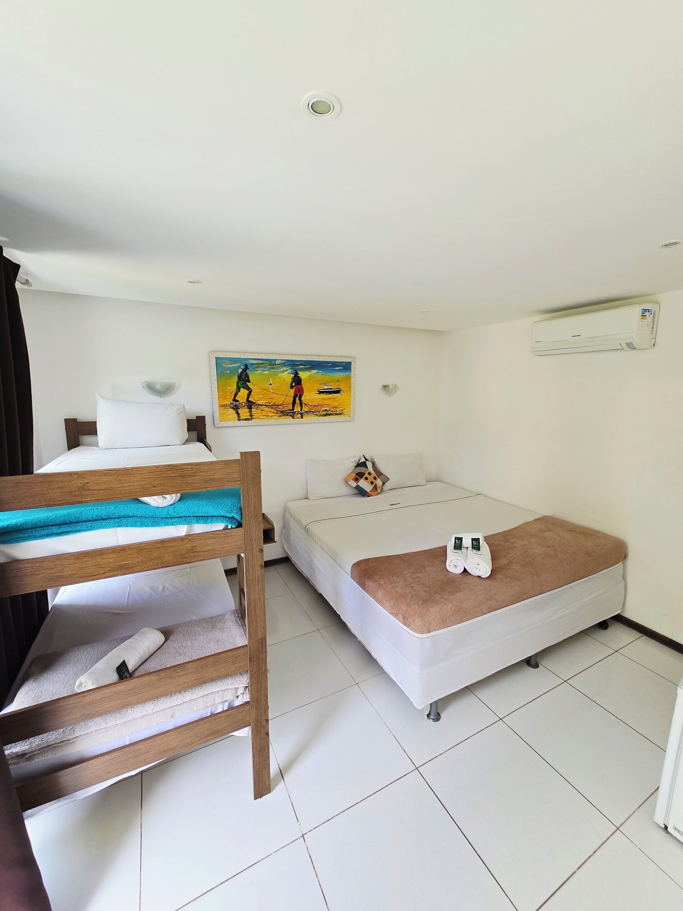 Standard Quadruple Room | Living area | TV