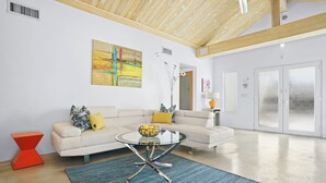 A modern living room with a white sofa, a glass coffee table, and a blue striped rug. - Palms Spring Doering Vista Estate (Palm Springs)