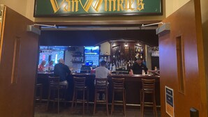 The interior of Van Winkle's bar with wooden bar stools and a bartender. - The ultimate resort experience. Pool, hot tub, sauna, steam room, exercise room. (Hunter)