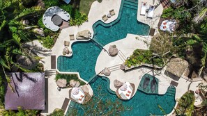 An aerial view of a resort with multiple swimming pools, lounge areas, and tropical landscaping. - Naviva, A Four Seasons Resort, Punta Mita, Mexico - All Inclusive (Punta de Mita)