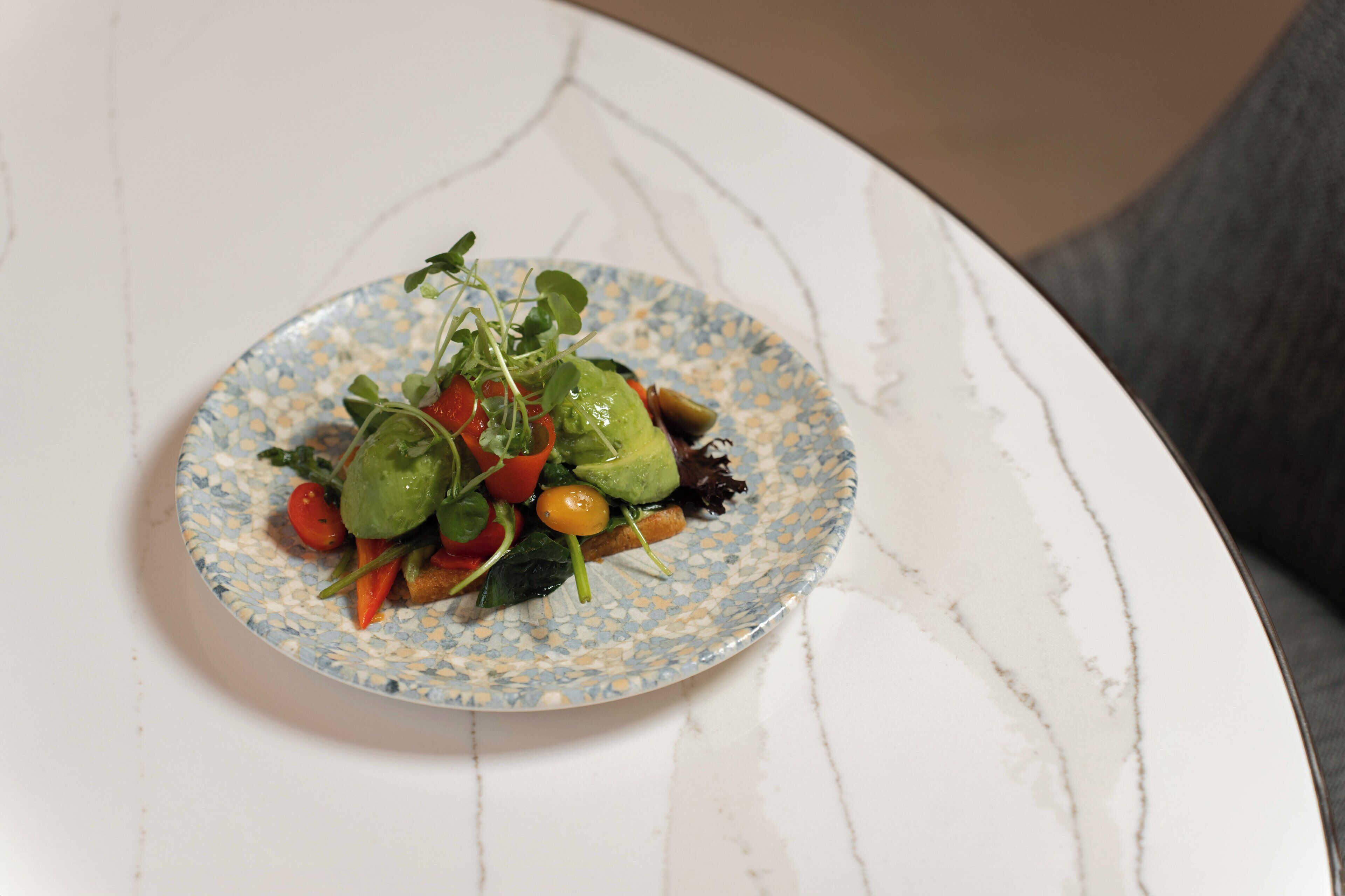 A plate of food on a white marble table.