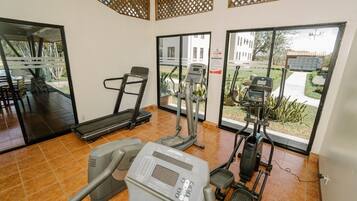 A gym with treadmills, an elliptical, and a stationary bike.