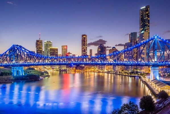 A cityscape with a prominent bridge and modern buildings.