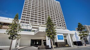 A tall hotel with a modern design, featuring a prominent entrance and a sign for 'Mantra on View Hotel.' - Comfy 2 Double-bed Hotel Room Next to BeachandTram (Surfers Paradise)