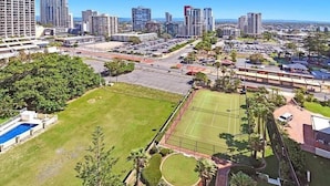 A residential area with a tennis court, swimming pool, and a parking lot.