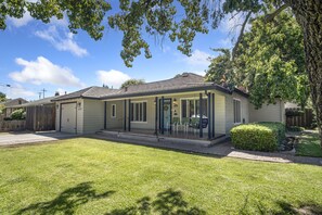 Surrounded by mature trees and a fence, this single-story home offers a secluded retreat.