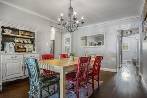 Enjoy meals in this stylish dining area with a wooden table and comfortable seating.