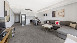 A modern apartment with a kitchen, dining area, and living room.