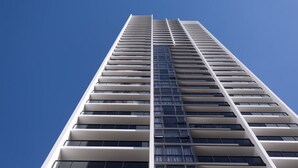 Un immeuble de grande hauteur doté d’une architecture moderne, caractérisé par une série de balcons et de grandes fenêtres.