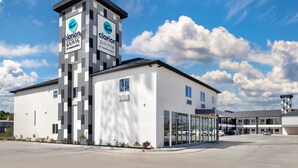 A modern hotel building with a prominent tower featuring signage for Clarion Pointe by Choice Hotels. - Clarion Pointe Spring - Houston North (Spring)