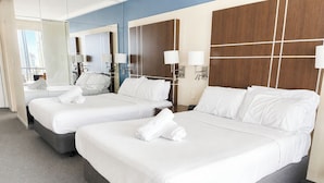 A hotel room with two beds, a large mirror, and a view of the city. - Ocean View 2 Double-bed Hotel Room | 2min to Beach (Surfers Paradise)