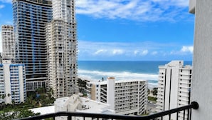 A coastal cityscape with high-rise buildings, a clear sky, and the ocean in the background. - Ocean View 2 Double-bed Hotel Room | 2min to Beach (Surfers Paradise)