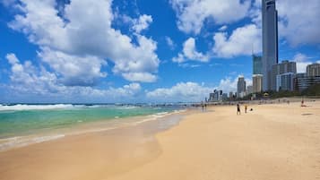 A beach with a city skyline in the background.