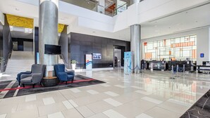 A spacious lobby with a check-in counter, seating area, and a staircase leading to upper levels. - Ocean View 2 Double-bed Hotel Room | 2min to Beach (Surfers Paradise)