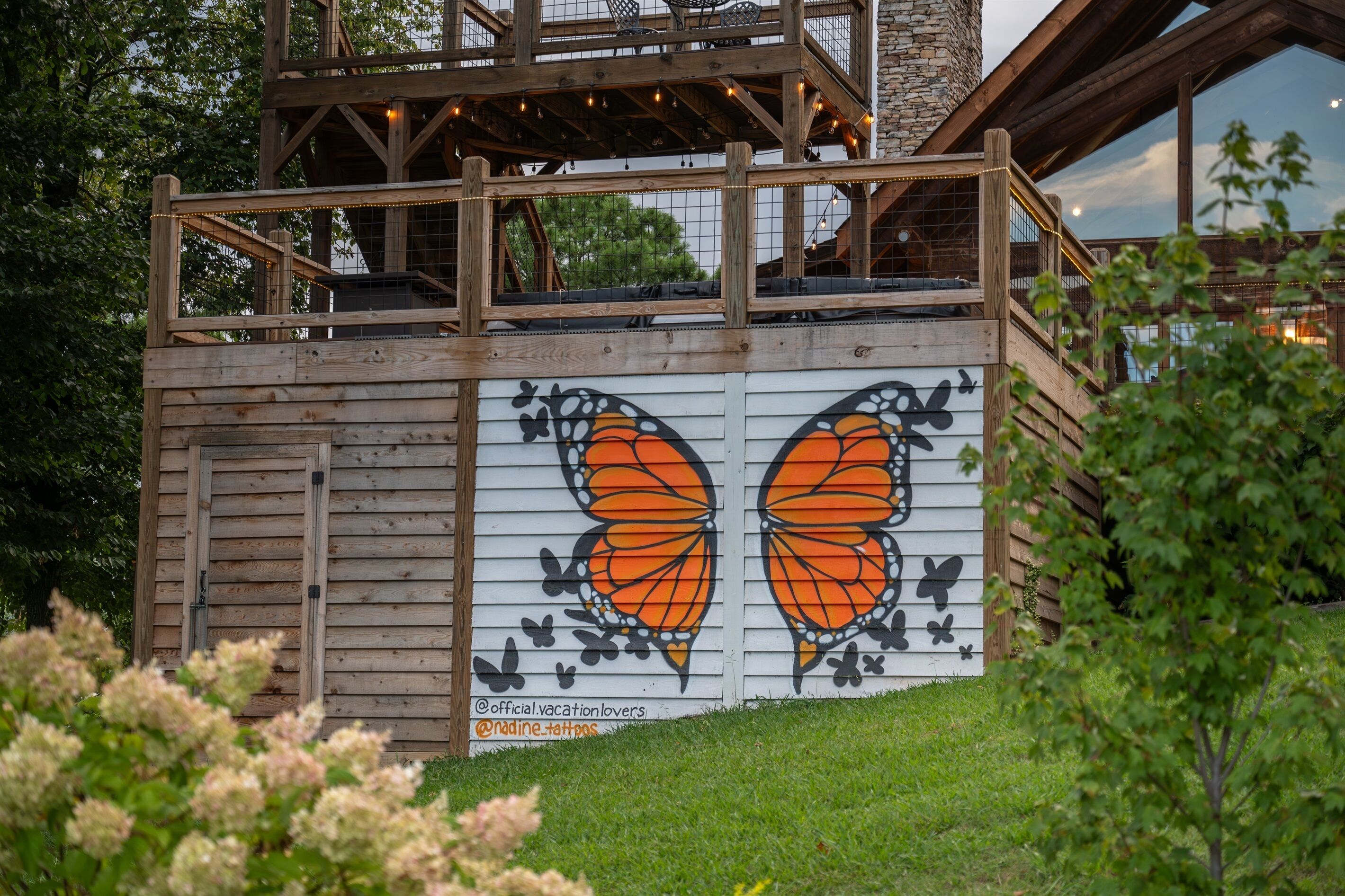 A wooden structure with a large butterfly mural on the side.