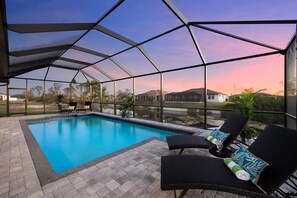 Outdoor pool, a heated pool - Escape to Cape! 4 bed 3 bath Canal Home w/ Heated Oversized Pool & 2 King Suites (Cape Coral)