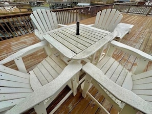 A wooden deck with a table and chairs.
