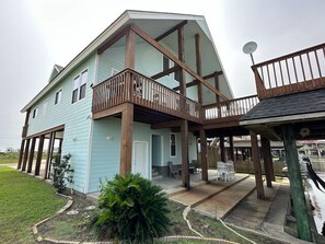 A two-story house with a balcony, a porch, and a satellite dish.