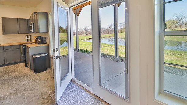 A modern kitchen with grey cabinets, a coffee machine, and a built-in oven. - Hunts Bend: Feel the Season Change|5-Acre Retreat (Bowling Green)