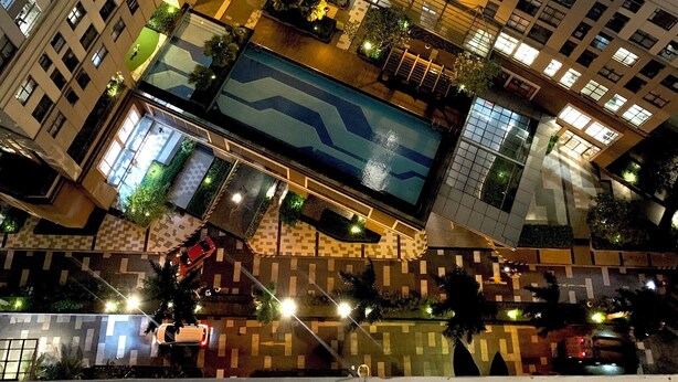 A high-rise building with multiple floors, balconies, and a central courtyard with a swimming pool. - Golden Apartment (Ho Chi Minh City)