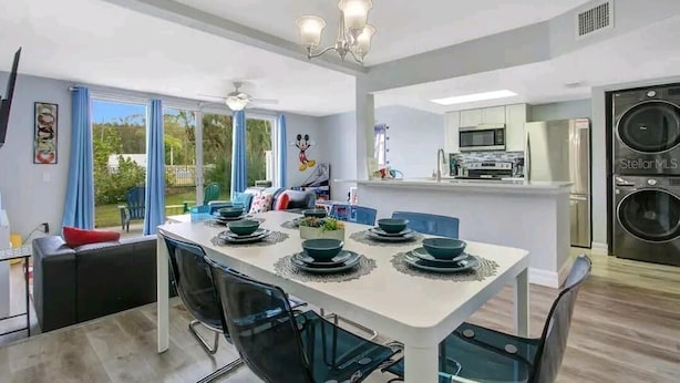 A modern kitchen with a built-in microwave, a refrigerator, and a washing machine.