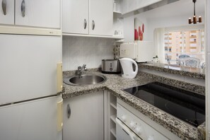 Fridge, microwave, stovetop, coffee/tea maker