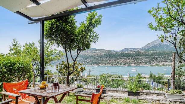 An outdoor patio with a table and chairs, overlooking a body of water and mountains. - Holiday Home 'Villa 2' with Sea View, Wi-Fi and Air Conditioning (Leykada)